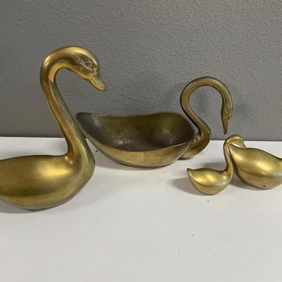 Brass swans head down