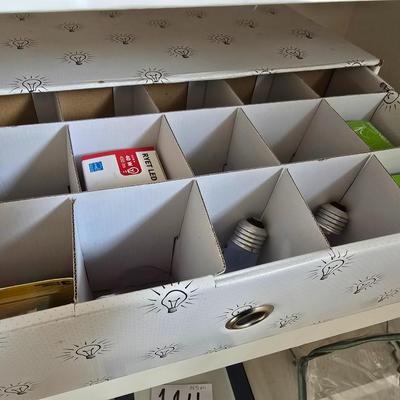 Light bulb storage box with Two extension cords and a blacklight flash light