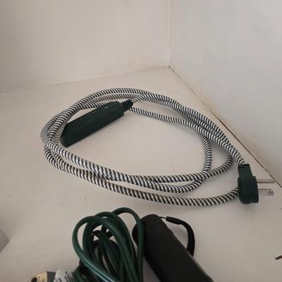 Light bulb storage box with Two extension cords and a blacklight flash light