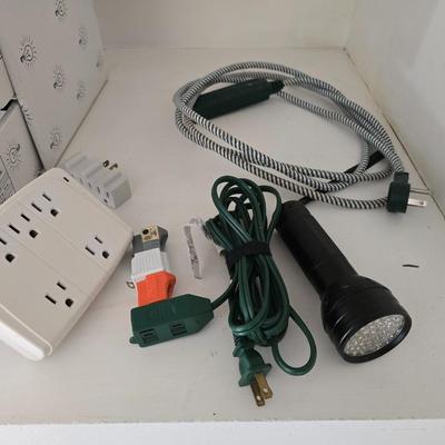 Light bulb storage box with Two extension cords and a blacklight flash light