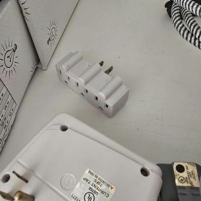 Light bulb storage box with Two extension cords and a blacklight flash light