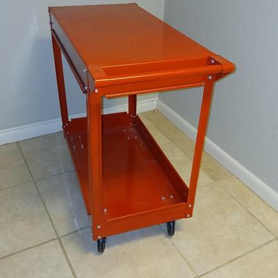 Red metal utility cart on wheels