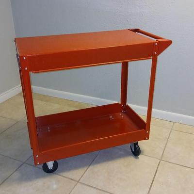 Red metal utility cart on wheels