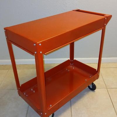 Red metal utility cart on wheels