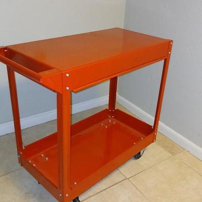 Red metal utility cart on wheels