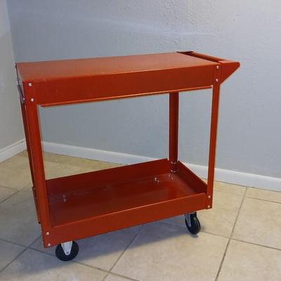 Red metal utility cart on wheels