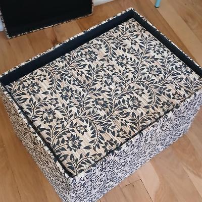 Two matching nesting fabric covered storage boxes with handles