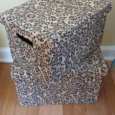 Two matching nesting fabric covered storage boxes with handles