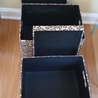Two matching nesting fabric covered storage boxes with handles