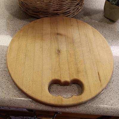 A BASKET OF REALISTIC FRUIT, CUTTING BOARD AND A FAUX FLOWER
