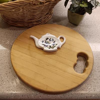 A BASKET OF REALISTIC FRUIT, CUTTING BOARD AND A FAUX FLOWER