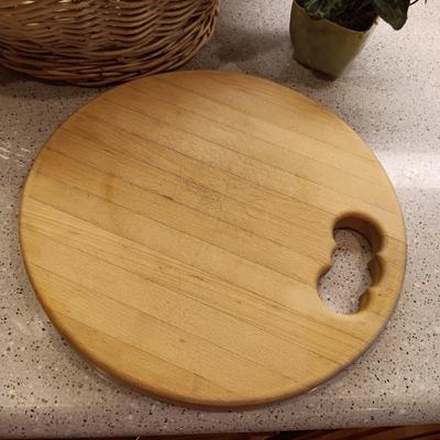 A BASKET OF REALISTIC FRUIT, CUTTING BOARD AND A FAUX FLOWER