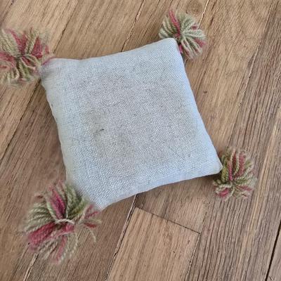 Handwoven basket and vintage needlepoint pin cushion