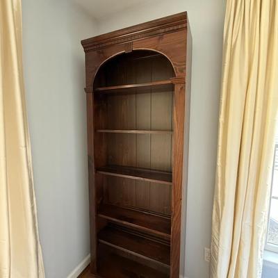 Wood bookshelf with arch detail