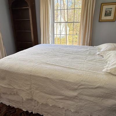 Queen size white detailed quilt, bed skirt and two shams.