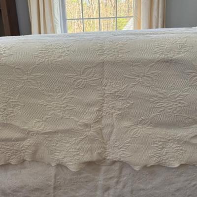 Queen size white detailed quilt, bed skirt and two shams.