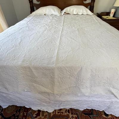 Queen size white detailed quilt, bed skirt and two shams.