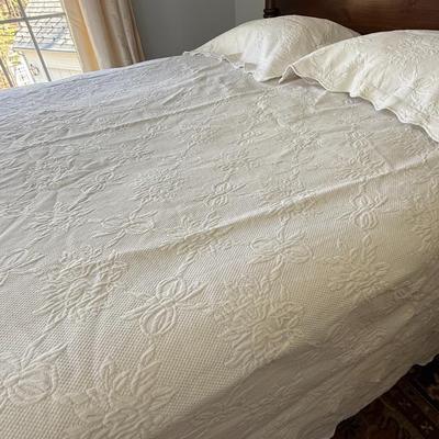 Queen size white detailed quilt, bed skirt and two shams.