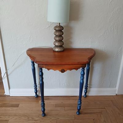 Antique half-round console table with nautical lamp