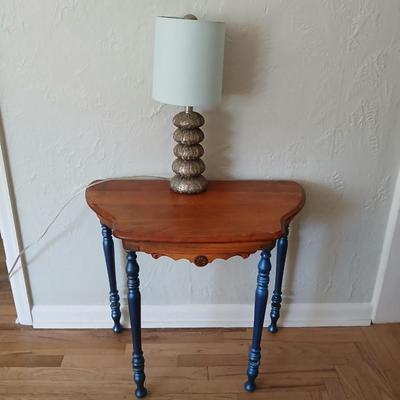 Antique half-round console table with nautical lamp