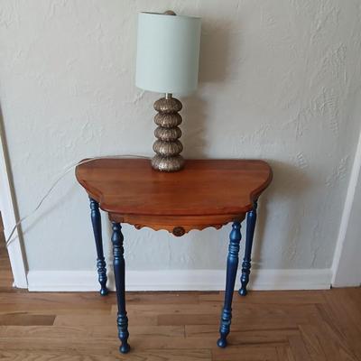 Antique half-round console table with nautical lamp