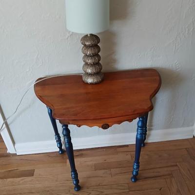 Antique half-round console table with nautical lamp