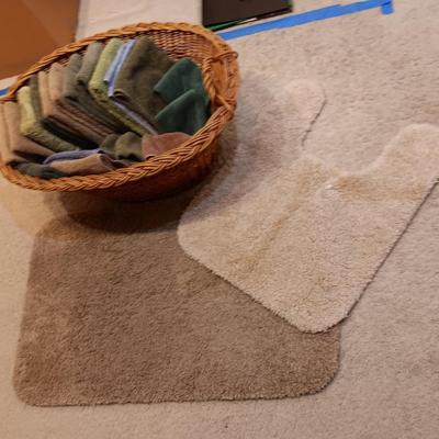 LARGE BASKET FULL OF HAND TOWELS AND WASHCLOTHS PLUS BATH RUGS