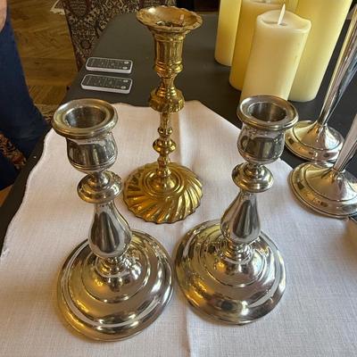 1 brass candlestick and a pair of pretty silver plate candlesticks