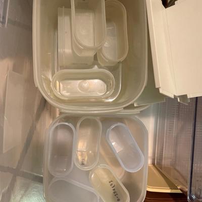 Tupperware spice containers in brown and black lids