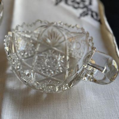 Two cut glass candy dishes with handles and silver rimmed bowl