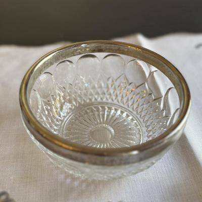 Two cut glass candy dishes with handles and silver rimmed bowl