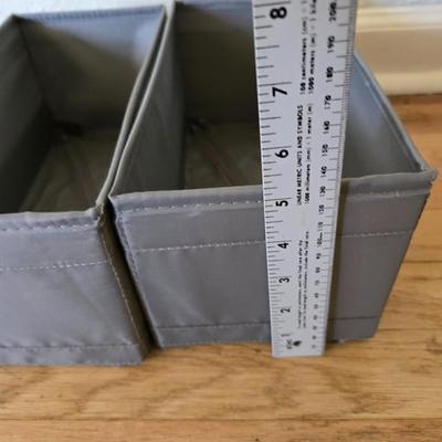 Five Cloth storage baskets and one plastic storage container