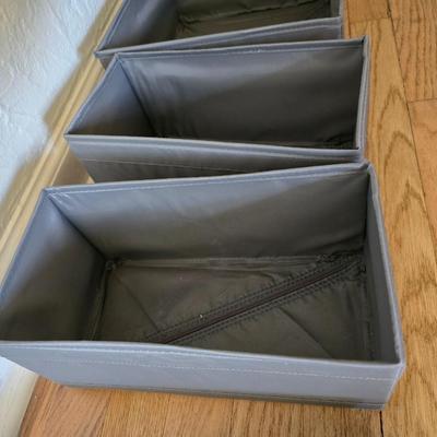 Five Cloth storage baskets and one plastic storage container