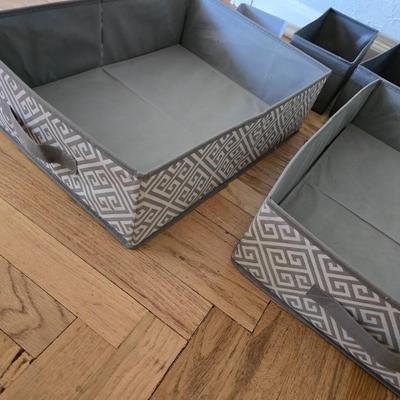 Five Cloth storage baskets and one plastic storage container
