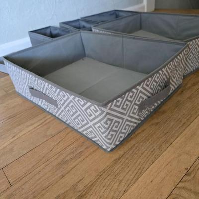 Five Cloth storage baskets and one plastic storage container