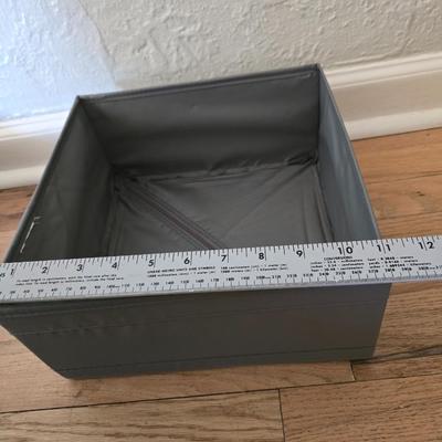 Five Cloth storage baskets and one plastic storage container