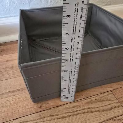 Five Cloth storage baskets and one plastic storage container