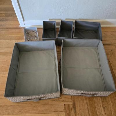 Five Cloth storage baskets and one plastic storage container