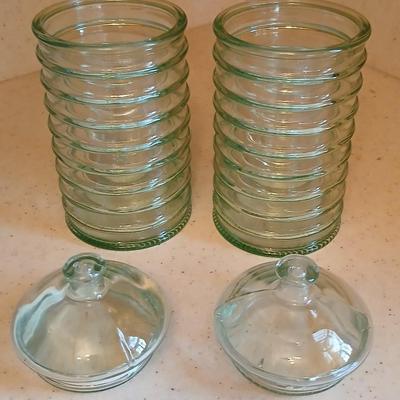 Two lidded ribbed glass storage containers with two small Cordon Bleu sauce dishes