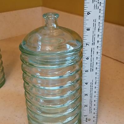 Two lidded ribbed glass storage containers with two small Cordon Bleu sauce dishes