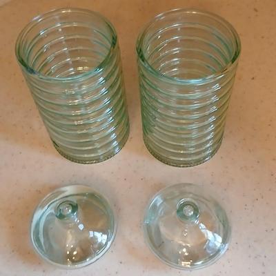 Two lidded ribbed glass storage containers with two small Cordon Bleu sauce dishes