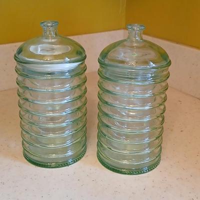 Two lidded ribbed glass storage containers with two small Cordon Bleu sauce dishes