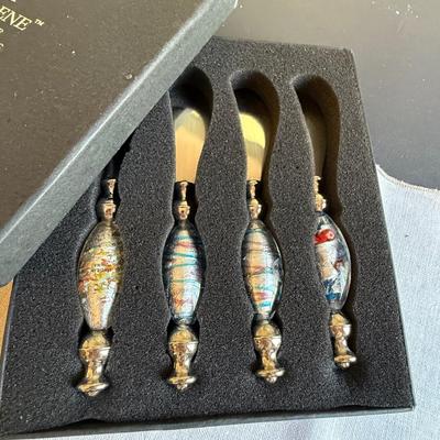 Assortment of antique silverware and Murano glass butter knives