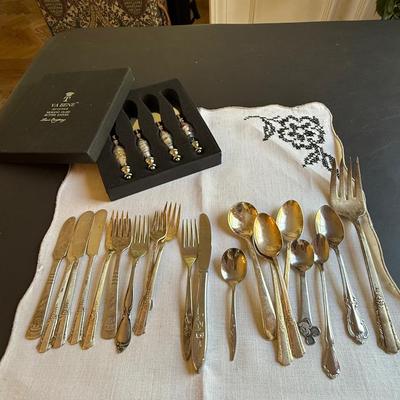 Assortment of antique silverware and Murano glass butter knives