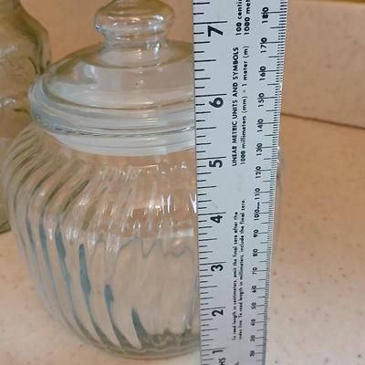 Three glass storage jars / canisters with lids