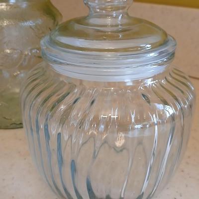 Three glass storage jars / canisters with lids