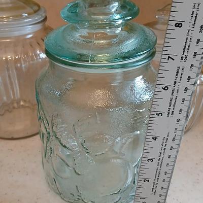 Three glass storage jars / canisters with lids