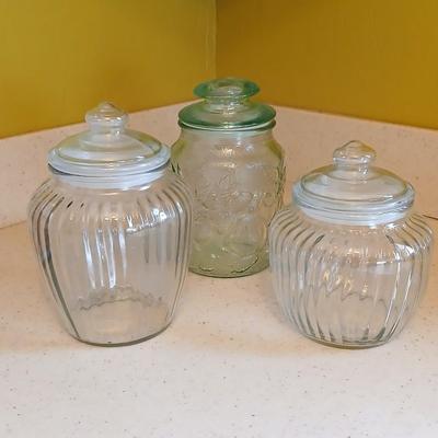Three glass storage jars / canisters with lids