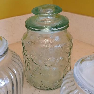 Three glass storage jars / canisters with lids