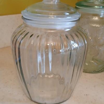 Three glass storage jars / canisters with lids